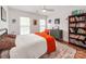 Bright bedroom with a ceiling fan, art collection, and a bookcase at the foot of the bed at 1605 Ambergate Dr, Waxhaw, NC 28173
