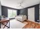 Bedroom with hardwood floors, a ceiling fan and desk space with natural light from the window at 1605 Ambergate Dr, Waxhaw, NC 28173