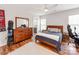 Modern bedroom with hardwood floors, large mirror dresser, and en-suite bathroom entrance at 1605 Ambergate Dr, Waxhaw, NC 28173
