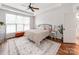 Bright bedroom with a ceiling fan, large window, and wooden chest at the foot of the bed at 1605 Ambergate Dr, Waxhaw, NC 28173