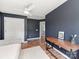 Bedroom with hardwood floors, a ceiling fan, a wooden desk and connected bathroom at 1605 Ambergate Dr, Waxhaw, NC 28173