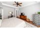 Bright bedroom featuring hardwood floors, a ceiling fan, a writing desk, and stylish decor at 1605 Ambergate Dr, Waxhaw, NC 28173