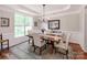 Elegant dining room with a large table, chairs, chandelier, and ample natural light at 1605 Ambergate Dr, Waxhaw, NC 28173