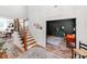 Bright foyer with wood floors, staircase with black railings, and access to an office space at 1605 Ambergate Dr, Waxhaw, NC 28173