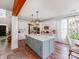 Kitchen with large island, white cabinets, stainless appliances, and hardwood floors at 1605 Ambergate Dr, Waxhaw, NC 28173