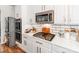 Kitchen details with white cabinets, subway tile backsplash, and stainless appliances at 1605 Ambergate Dr, Waxhaw, NC 28173