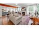Open living room with fireplace, hard wood floors, natural light, and exposed beam at 1605 Ambergate Dr, Waxhaw, NC 28173