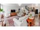 Open living room with staircase, hard wood floors, natural light, and cozy furniture at 1605 Ambergate Dr, Waxhaw, NC 28173