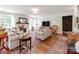 Bright living room with fireplace, hard wood floors, natural light, and cozy furniture at 1605 Ambergate Dr, Waxhaw, NC 28173