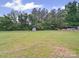 Expansive grassy backyard featuring mature trees and a storage shed at 197 Horseshoe Loop, Statesville, NC 28625
