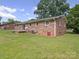 Back exterior features brick siding, a sliding glass door and a lush green lawn at 197 Horseshoe Loop, Statesville, NC 28625