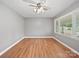 Bedroom with hardwood floors, neutral wall paint, a ceiling fan and bright windows at 197 Horseshoe Loop, Statesville, NC 28625