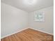Cozy bedroom with wood-look floors, a window, and neutral colored walls at 197 Horseshoe Loop, Statesville, NC 28625