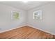 Bedroom featuring laminate flooring and two bright windows at 197 Horseshoe Loop, Statesville, NC 28625