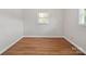 Bedroom with laminate wood-look flooring and two windows at 197 Horseshoe Loop, Statesville, NC 28625
