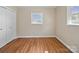 A bright bedroom with wood-look flooring, a closet, and a window at 197 Horseshoe Loop, Statesville, NC 28625