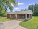 Charming brick home featuring a covered carport and well-maintained landscaping at 197 Horseshoe Loop, Statesville, NC 28625