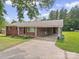 Charming brick home with a covered carport and fresh green lawn at 197 Horseshoe Loop, Statesville, NC 28625