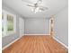 Bright living room with hardwood floors, a ceiling fan, and ample natural light at 197 Horseshoe Loop, Statesville, NC 28625
