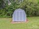 Well-maintained storage shed with a clean appearance and double-door entry at 197 Horseshoe Loop, Statesville, NC 28625