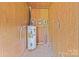 Small utility room with light wood paneling and a newer water heater at 197 Horseshoe Loop, Statesville, NC 28625