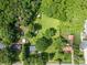 An aerial view of a property with large, grassy yard surrounded by trees and neighborhood at 2008 Kimway Dr, Matthews, NC 28105