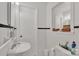 A tidy bathroom showcasing a classic pedestal sink and tiled walls at 2008 Kimway Dr, Matthews, NC 28105
