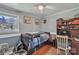 Modest bedroom features a twin bed, wood floors, and a view to the outdoors at 2008 Kimway Dr, Matthews, NC 28105