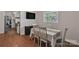 Cozy dining area features hardwood floors, white furniture, and an abundance of natural light at 2008 Kimway Dr, Matthews, NC 28105