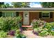 Inviting brick home entrance surrounded by vibrant, colorful landscaping at 2008 Kimway Dr, Matthews, NC 28105