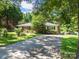Charming brick ranch home with a long driveway and lush front yard at 2008 Kimway Dr, Matthews, NC 28105