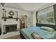 Inviting main bedroom with fireplace, wood floors, a comfortable bed, and lots of natural light at 2008 Kimway Dr, Matthews, NC 28105