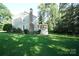 Backyard featuring a well-maintained lawn, mature trees, and a screened in porch at 2087 Poinsett Dr, Rock Hill, SC 29732