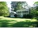 Charming two-story home with a well-manicured lawn and lush trees creating a picturesque setting at 2087 Poinsett Dr, Rock Hill, SC 29732