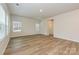 Light-filled living room with laminate flooring, neutral walls, and windows for a bright and inviting space at 2136 Sunflower Cir, Newton, NC 28658