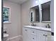 Modern bathroom featuring double sinks with granite countertops, complemented by stylish mirrors and fixtures at 218 Hartman St, Gastonia, NC 28052