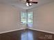 Bedroom with a ceiling fan, corner windows providing natural light, and hardwood floors, creating a cozy space at 218 Hartman St, Gastonia, NC 28052