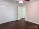 Spacious bedroom featuring hardwood flooring, a ceiling fan, and ample closet space, creating an inviting atmosphere at 218 Hartman St, Gastonia, NC 28052