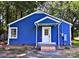 Exterior shot of blue cottage-style home with crisp white trim, showcasing charming curb appeal at 218 Hartman St, Gastonia, NC 28052