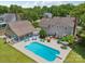 Aerial view of the property showcasing the pool, patio, lawn and detached garage at 2256 Drawbridge Ct, Rock Hill, SC 29732