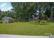 Backyard featuring lush green lawn, shed and tropical garden at 2256 Drawbridge Ct, Rock Hill, SC 29732