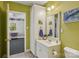 Bright bathroom with green walls, vanity, mirror, and view to bonus room at 2256 Drawbridge Ct, Rock Hill, SC 29732
