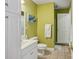 Bathroom with green walls, white cabinets, commode, and view to shower at 2256 Drawbridge Ct, Rock Hill, SC 29732