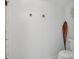 Bright bathroom featuring a white toilet, decorative wall hooks, and stylish coastal decor at 2256 Drawbridge Ct, Rock Hill, SC 29732