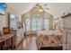 Charming bedroom with vaulted ceilings, multiple windows, hardwood floors, and a decorative ceiling fan at 2256 Drawbridge Ct, Rock Hill, SC 29732