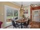 Bright dining area with pool views features a modern light fixture, hardwood floors, and access to outdoor amenities at 2256 Drawbridge Ct, Rock Hill, SC 29732