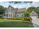 Well-maintained house features blue shutters, a lush lawn, and a detached garage with matching architectural details at 2256 Drawbridge Ct, Rock Hill, SC 29732