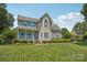 Charming two-story home with blue shutters, covered porch, and manicured lawn under a sunny blue sky at 2256 Drawbridge Ct, Rock Hill, SC 29732