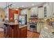 A kitchen features stainless steel appliances, granite counters, and custom island at 2256 Drawbridge Ct, Rock Hill, SC 29732