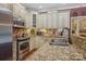 A spacious kitchen features granite countertops, stainless steel appliances, and custom cabinets at 2256 Drawbridge Ct, Rock Hill, SC 29732